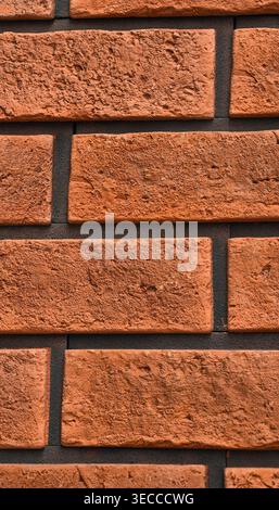 Brick wall texture with detailed red brown bricks, black mortar and realistic surface imperfections. 8K ultra high resolution background for design Stock Photo
