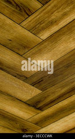 Warm brown wooden herringbone texture with golden honey tones, detailed grain and geometric parquet pattern. High resolution 8K background for design Stock Photo