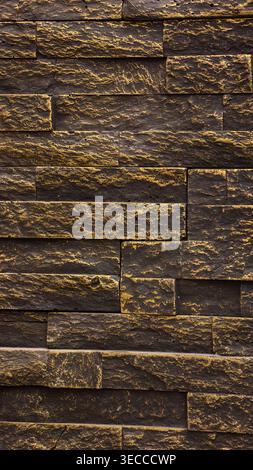 Dark natural stone wall texture with layered black and gray slabs, rough surface detail and warm mineral accents. High resolution 8K background Stock Photo