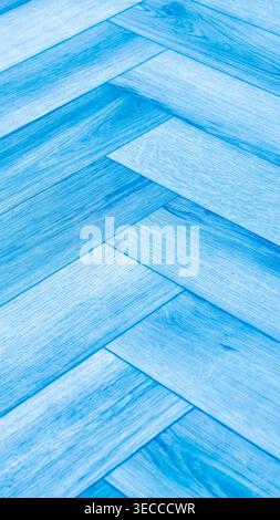 Blue wooden herringbone texture with light and dark blue planks, detailed grain and geometric pattern. High resolution 8K background for design Stock Photo