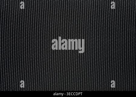 Close up shot of a dark black textured synthetic fabric material Stock Photo