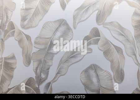 Subtle botanical leaf pattern on light grey wallcovering Stock Photo