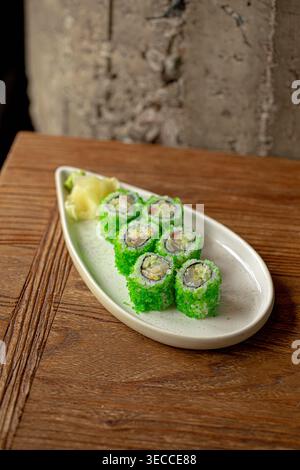 Sushi rolls with green coating and ginger Stock Photo