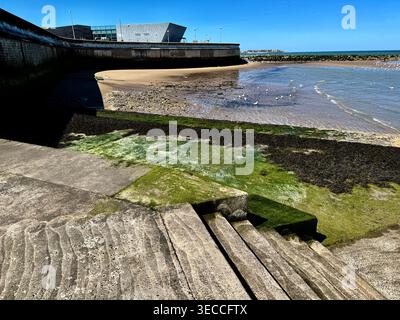 View overlooking the sandy Colwyn Bay beach and the broader Bay of Colwyn, which is part of the Irish Sea coastline, Porth Erias Centre in distance Stock Photo