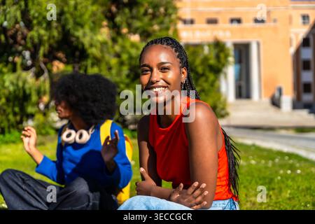Happy students sharing a laugh on university campus Stock Photo
