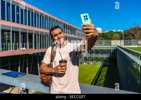 University student taking selfie with smartphone on campus Stock Photo