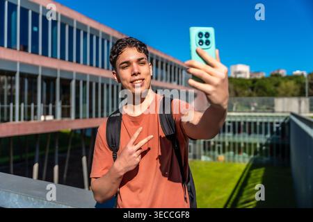 Young student taking selfie with smartphone on campus Stock Photo