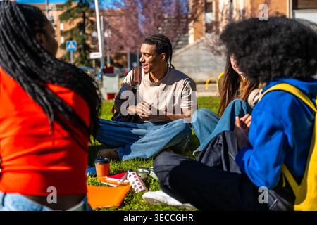 Diverse students talking and sharing moments on university campus Stock Photo