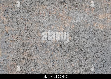 Front view of a grey concrete wall texture with peeling and decayed plaster Stock Photo