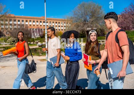 Diverse group of university students walking on campus Stock Photo