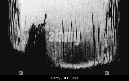 Dry brush paint strokes Front view of an abstract black and white texture with paint drips and cracked patterns Stock Photo