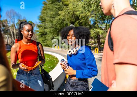 Diverse students conversing and learning on university campus Stock Photo