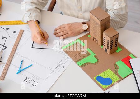 Male construction engineer working on 3D zoning plan in office, closeup Stock Photo