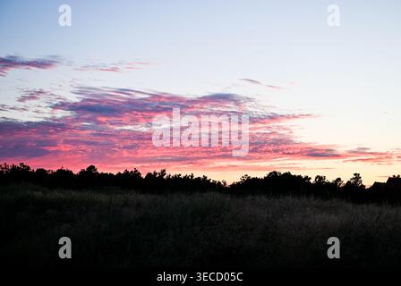 Pink Sunset Sky over Skagen Denmark with Dramatic Clouds and Silhouette Landscape Stock Photo