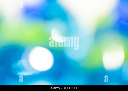 Abstract blue and green bokeh background with glowing white circles and soft defocused light effect Stock Photo