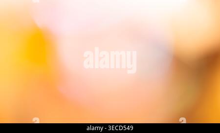 Soft abstract blur of warm yellow orange and pastel pink for a dreamy sunset background Stock Photo