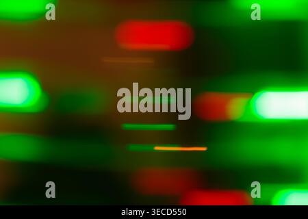 Abstract blurred green and red neon light bokeh on a dark background with glowing oval shapes Stock Photo