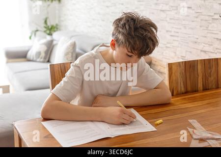 School boy, elementary school boy, preparing for exams for middle school at home, learning math and language Stock Photo