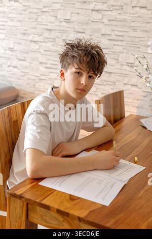 School boy, elementary school boy, preparing for exams for middle school at home, learning math and language Stock Photo