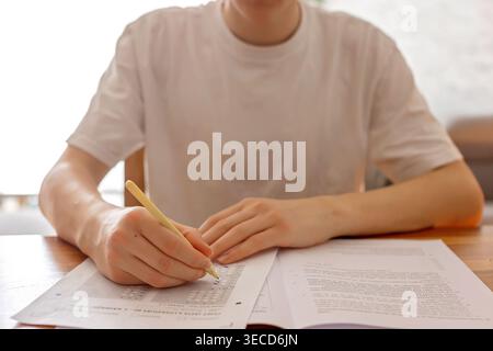 School boy, elementary school boy, preparing for exams for middle school at home, learning math and language Stock Photo