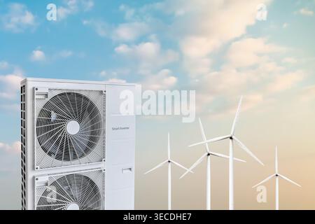 Double heat pump in front of wind turbines against a moody blue sky Stock Photo