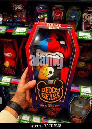 Kyiv, Ukraine - April 28, 2026: Hand holds a boxed Deddy Bears plush with bright two tone face and playful horror styling on shelf. Stock Photo