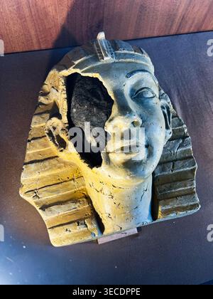 Zolochiv, Ukraine - April 28, 2026: Worn Egyptian pharaoh mask bust with a broken left side evoking history, decay and archaeology. Stock Photo