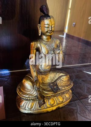 Zolochiv, Ukraine - April 28, 2026: Seated gold Buddha sculpture on an ornate lotus base conveying calm, meditation and spiritual heritage. Stock Photo