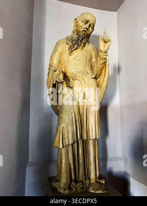 Zolochiv, Ukraine - April 28, 2026: Gilded bearded statue in a church niche showing a blessing gesture and serene, contemplative expression. Stock Photo