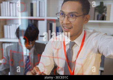 Business professional explaining ideas and planning strategy during meeting, using visual thinking to communicate concepts, solve problems and support Stock Photo