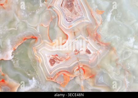 Front view close up of a polished green onyx stone with dramatic orange concentric patterns Stock Photo