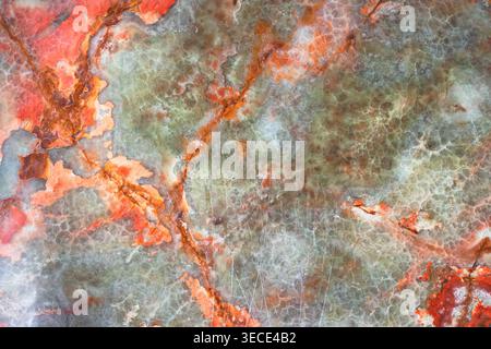 Front view macro shot of a vibrant multi colored marble slab with green and orange patterns Stock Photo