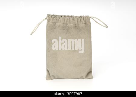 A soft plush gray velvet drawstring pouch bag featuring braided twisted cord closure loops on both sides, photographed cleanly isolated on a white stu Stock Photo