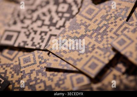 Close up of a black and white many QR codes printed on brown cardboard Stock Photo