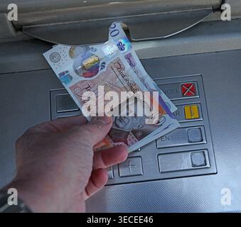 King Charles III £10 £20 Bank of England note dispensed from a UK ATM cash machine, marking the new monarch on British money. Stock Photo