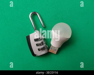 A miniature toy boat sits beside a silver magnetic compass on a light blue background, symbolizing guided maritime travel. Stock Photo