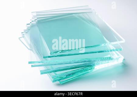 Stack of glass sheets on light background, closeup Stock Photo