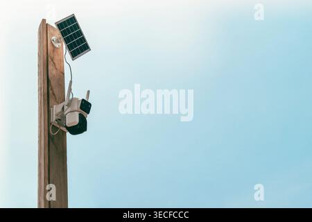 Solar-powered outdoor CCTV camera mounted on a pole. Security system Stock Photo