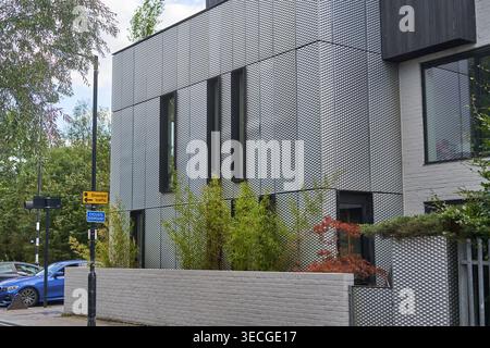 A modern residential building in London featuring a distinctive textured metal facade with a diamond pattern. The structure has tall, narrow vertical Stock Photo