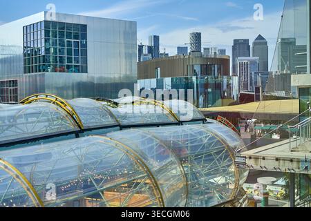 Modern architectural scene in London featuring distinctive curved transparent glass domes with golden metal frames in the foreground, likely part of Stock Photo