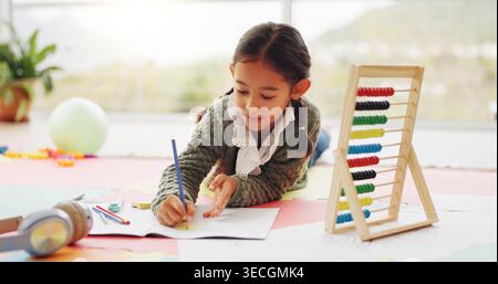 Child, student and writing with notebook in home for education, studying and maths homework. Girl, kid and sticky notes with stationery for learning Stock Photo