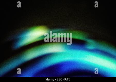 Abstract dark background with grainy texture and glowing green and blue curved lights Stock Photo