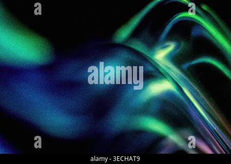 Dark grainy abstract background showing dynamic fluid lines of green and blue light Stock Photo