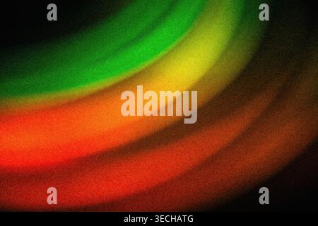 Colorful abstract grainy texture displaying concentric glowing arcs in red orange yellow and green Stock Photo