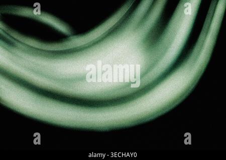 Flowing abstract green luminous waves with vintage grainy noise background Stock Photo