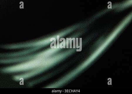 Diagonal green light streaks glowing against a black noisy background Stock Photo