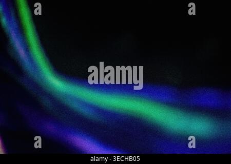 Glowing green and purple abstract film burn streaks on a dark background Stock Photo