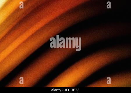 Diagonal abstract light rays in warm orange and brown with noise texture Stock Photo