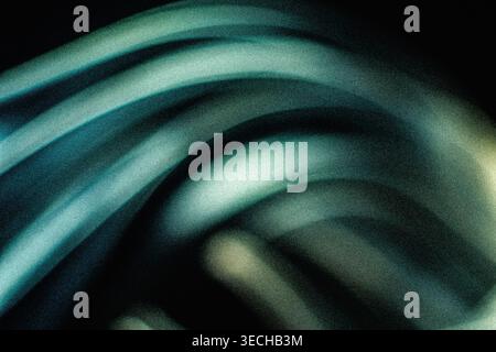 Curved teal and cyan grainy light patterns on black Stock Photo