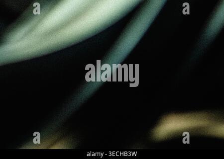 Abstract dark background with grainy teal light streaks and retro film texture Stock Photo